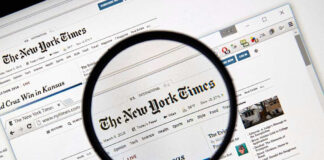 Magnifying glass over The New York Times website.