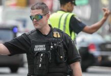 A Secret Service agent directing traffic in an urban setting