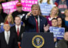 Trump’s Dual Memorial Day Message Shocks Nation Person speaking at rally with crowd behind podium