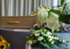 Billionaire Visionary DEAD — Built Media Giant White roses in front of a casket.