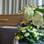 Billionaire Visionary DEAD — Built Media Giant White roses in front of a casket.