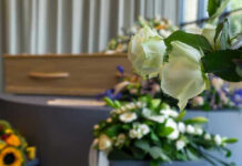 Billionaire Visionary DEAD — Built Media Giant White roses in front of a casket.
