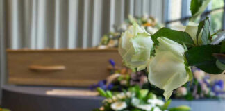 Billionaire Visionary DEAD — Built Media Giant White roses in front of a casket.