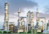 Global Oil Reserves PLUMMET – Shortage Looms! Industrial plant with metal towers and pipes.