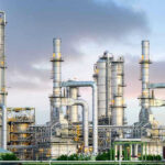 Global Oil Reserves PLUMMET – Shortage Looms! Industrial plant with metal towers and pipes.