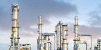 Global Oil Reserves PLUMMET – Shortage Looms! Industrial plant with metal towers and pipes.