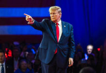 Surprise Launch – Trump’s NEW App Goes Live! Person in suit pointing during a public event.
