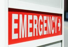 E-Coli Breaks Out Across Beloved Chain – Child Hospitalized! Emergency sign indicating direction with a red background and white text