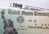 Trump Accounts SKYROCKET – But There’s a Catch! Close-up of a U.S. Treasury check and tax form 1040