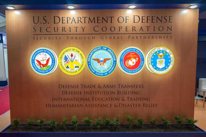 U.S. Department of Defense Security Cooperation display with logos.