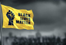 Black Panther Party INVADES Courthouse During Trial! Yellow Black Lives Matter flag with clenched fist.