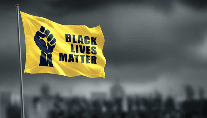 Yellow Black Lives Matter flag with clenched fist.
