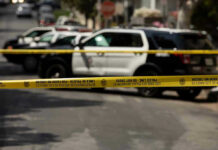 Pregnant Woman Stabbed — ‘Intent To Kill’ Charge Police tape blocking street with patrol cars.