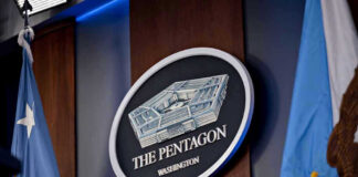 Helicopter Gunned Down Near Hormuz – Trump Fires Response! The Pentagon emblem between two flags.
