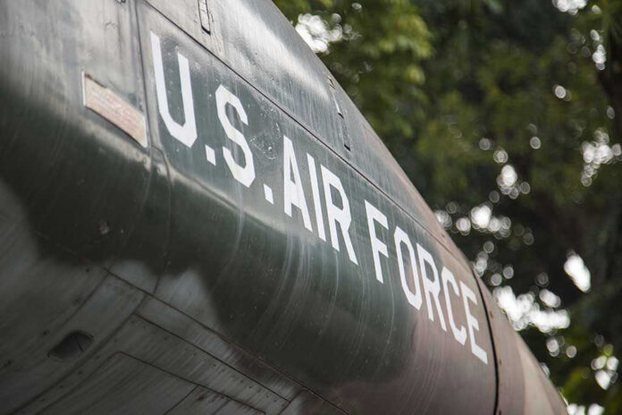 624049181 U.S. Air Force plane with trees in background.