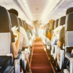 Airplane Passengers Toenails Spark Outrage! Passengers seated inside an airplane cabin.
