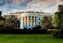 Trump Team SCRAMBLES – Situation Room Bugged! The White House surrounded by greenery and a fountain in the foreground