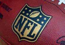 Shock Death Rocks NFL – 49ers Star GONE! Close-up of an NFL football with the logo prominently displayed