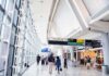 Airports’ Four-Letter Code You Don’t Want On Your Boarding Pass Interior of an airport terminal with travelers and signage