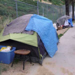 World Cup Clean-Up Sparks Liberal Fury Tents and belongings set up along sidewalk.