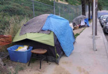 World Cup Clean-Up Sparks Liberal Fury Tents and belongings set up along sidewalk.