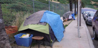 World Cup Clean-Up Sparks Liberal Fury Tents and belongings set up along sidewalk.