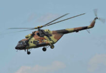 Air Force Helicopter Makes Emergency Landing in DC Camouflage military helicopter in flight against blue sky.