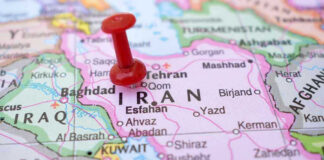 Mamdani Schedules SECRET Meeting With Iran Leaders! Red pushpin marking Iran on a map.