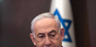 Fox News Host BLASTS Netanyahu – Makes Him SQUIRM Man in suit with Israeli flag in background.