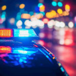 Triple Deported Illegal Murders 6-Year-Old Girl! Police car with flashing lights at night.