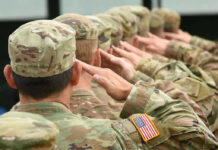 National Guard Soldiers Kill Civilian During Armed Pursuit! Soldiers in uniform saluting, American flag patch visible.