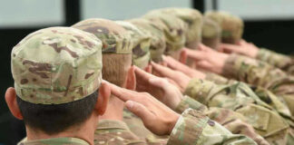 National Guard Soldiers Kill Civilian During Armed Pursuit! Soldiers in uniform saluting, American flag patch visible.