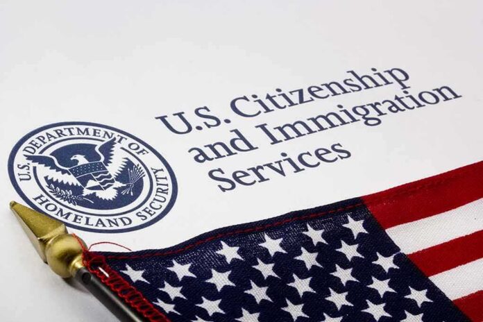 shutterstock_101132716 U.S. Citizenship and Immigration Services document with American flag