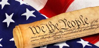 Rolled U.S. Constitution on an American flag