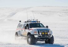 100 Tourists TRAPPED in Snow Storm Lifted white expedition truck driving through snowy terrain