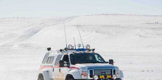 100 Tourists TRAPPED in Snow Storm Lifted white expedition truck driving through snowy terrain