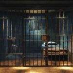 Prison cell with metal bars and a single bed