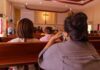 Knifeman STABS Woman Praying in Church people seated in church pews facing a cross