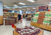 Groceries About To Cost MORE After Latest Bill Passed Interior of a grocery store with customers shopping for fresh produce