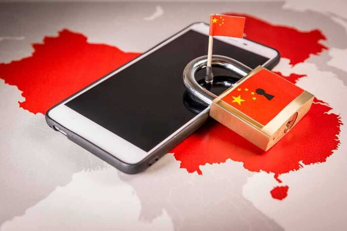 shutterstock_1083784346 Smartphone with padlock and small flag on map of China