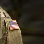 american flag patch on camouflage uniform sleeve