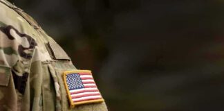 american flag patch on camouflage uniform sleeve