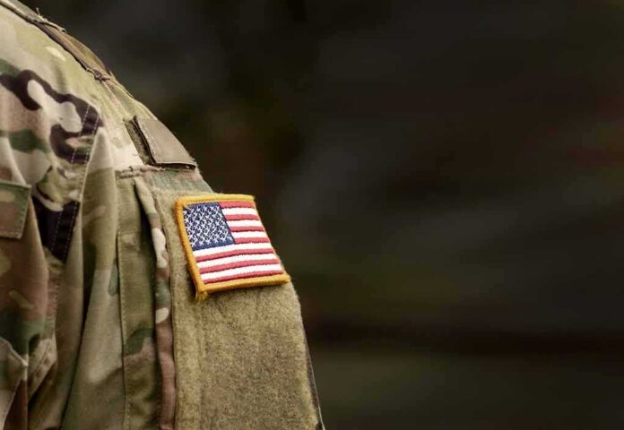 shutterstock_1711682218 american flag patch on camouflage uniform sleeve