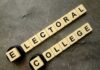 Governor’s Bombshell: Scrap Electoral College Letter tiles spelling electoral college on a gray surface
