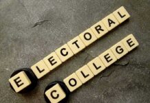 Letter tiles spelling electoral college on a gray surface