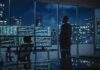 Trader in a dark office with multiple stock monitors and city skyline at night
