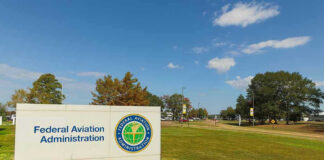 Federal Aviation Administration sign on grassy lawn.