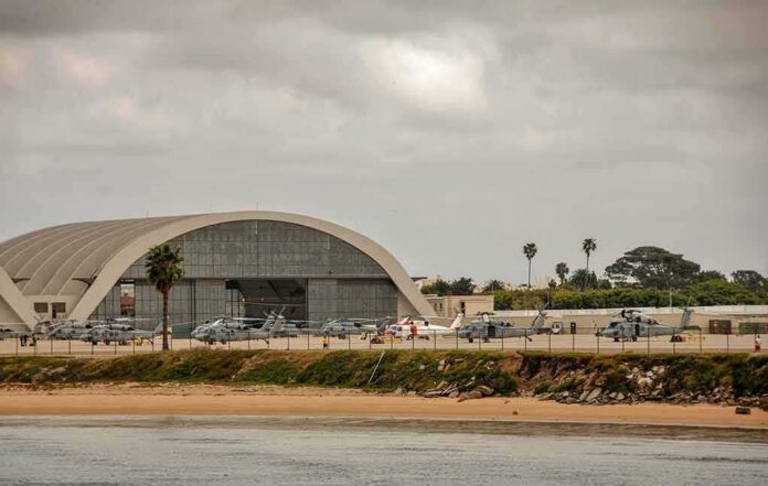 airport hangar with helicopters near a shoreline