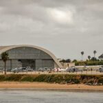 Bomb Scare ROCKS US Air Base airport hangar with helicopters near a shoreline