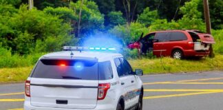 Dem Candidate ARRESTED – Handcuffed in Squad Car Police SUV with flashing lights at roadside crash scene